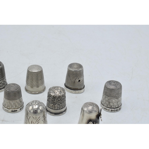 70 - A collection of silver thimbles to include a set of three with etched star, by Henry Griffiths and S... 