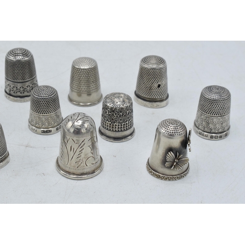 70 - A collection of silver thimbles to include a set of three with etched star, by Henry Griffiths and S... 