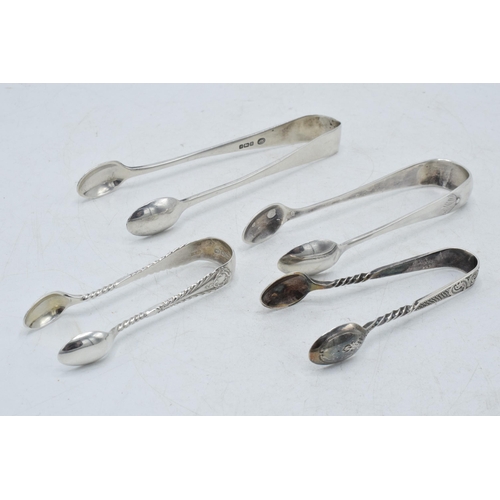 71 - A collection of hallmarked silver sugar tongs to include a plain pair and others with ornate designs... 