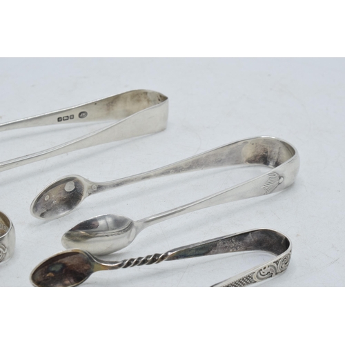 71 - A collection of hallmarked silver sugar tongs to include a plain pair and others with ornate designs... 