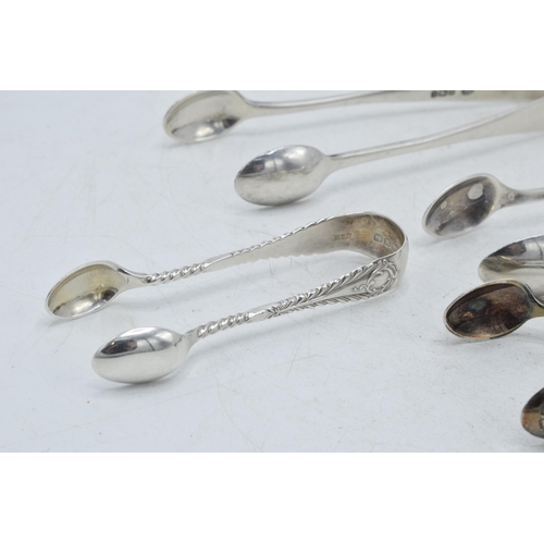 71 - A collection of hallmarked silver sugar tongs to include a plain pair and others with ornate designs... 