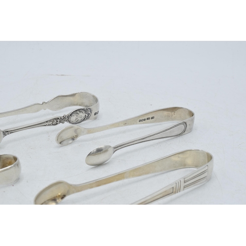 72 - A collection of hallmarked silver sugar tongs to include a pair with scaled claw nips and other desi... 