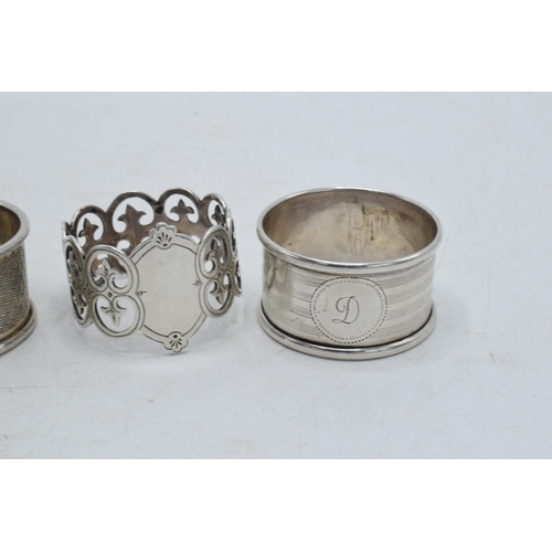 76 - A trio of silver napkin rings to include Birmingham 1917, Emile Viner of Sheffield, and Birmingham 1... 