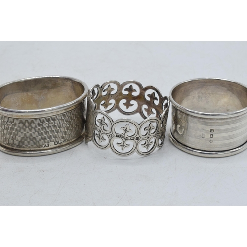 76 - A trio of silver napkin rings to include Birmingham 1917, Emile Viner of Sheffield, and Birmingham 1... 