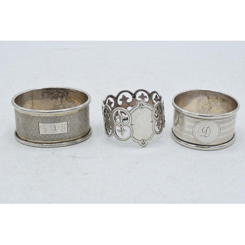 76 - A trio of silver napkin rings to include Birmingham 1917, Emile Viner of Sheffield, and Birmingham 1... 