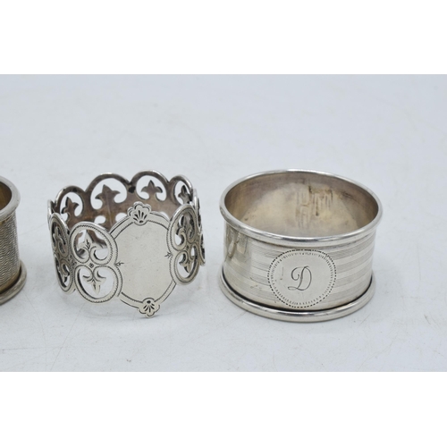 76 - A trio of silver napkin rings to include Birmingham 1917, Emile Viner of Sheffield, and Birmingham 1... 