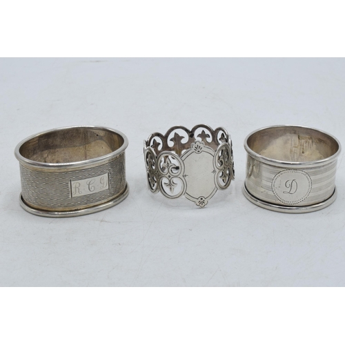 76 - A trio of silver napkin rings to include Birmingham 1917, Emile Viner of Sheffield, and Birmingham 1... 