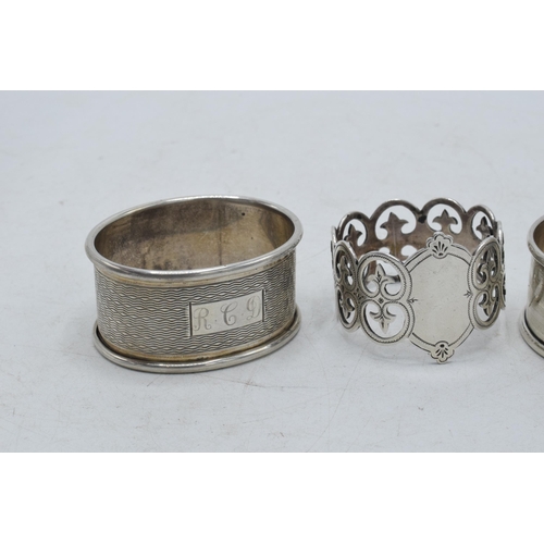 76 - A trio of silver napkin rings to include Birmingham 1917, Emile Viner of Sheffield, and Birmingham 1... 