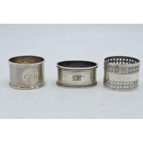 79 - A trio of silver napkin rings of varying designs to include Martin, Hall & Co Sheffield 1881, Colin ... 