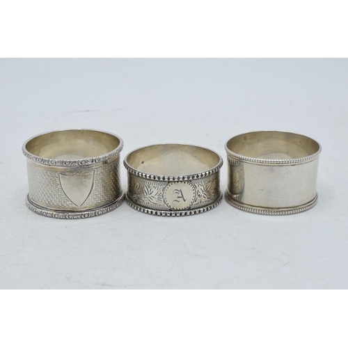 80 - A trio of silver napkin rings to include William Thorneymark Birmingham 1900, Robert Pringle & Sons ... 