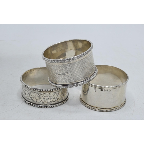 80 - A trio of silver napkin rings to include William Thorneymark Birmingham 1900, Robert Pringle & Sons ... 