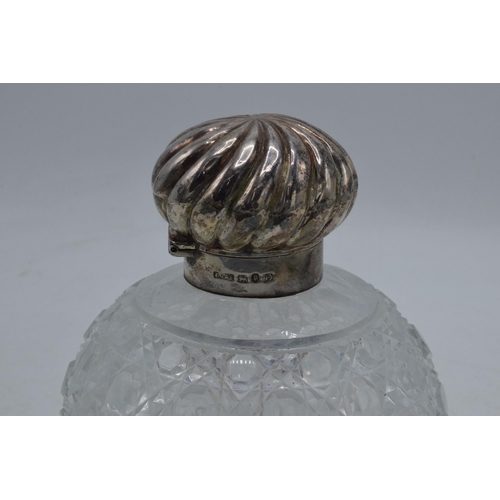 83 - Silver topped cut glass globular scent bottle with swirl decoration lid, Birmingham 1889, with stopp... 