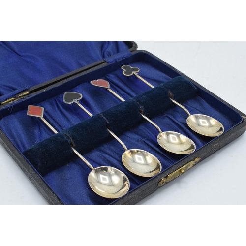 85 - A set of 4 hallmarked silver tea spoons, handles decorated with enamelled card suits, Birmingham 192... 