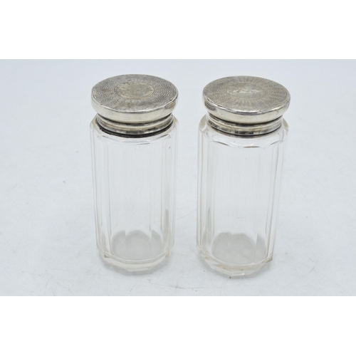 94 - A pair of silver topped dressing table jars, 9.5cm tall, London 1910 (2).