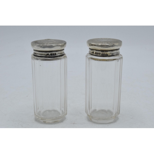 94 - A pair of silver topped dressing table jars, 9.5cm tall, London 1910 (2).