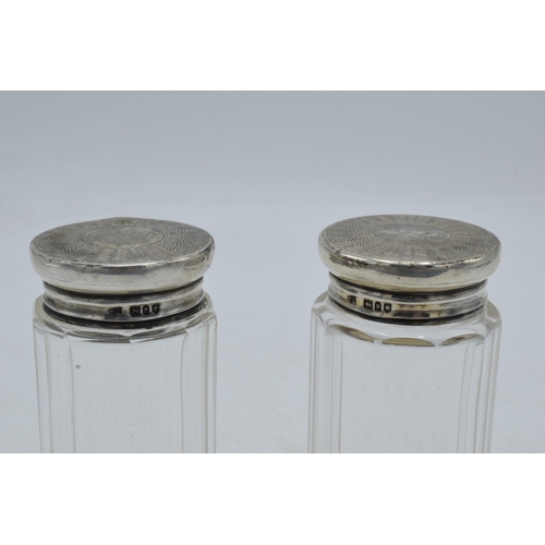 94 - A pair of silver topped dressing table jars, 9.5cm tall, London 1910 (2).