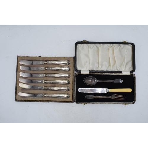 96 - A cased set of 6 silver handled butter knives, Sheffield 1926, together with a cased christening set... 