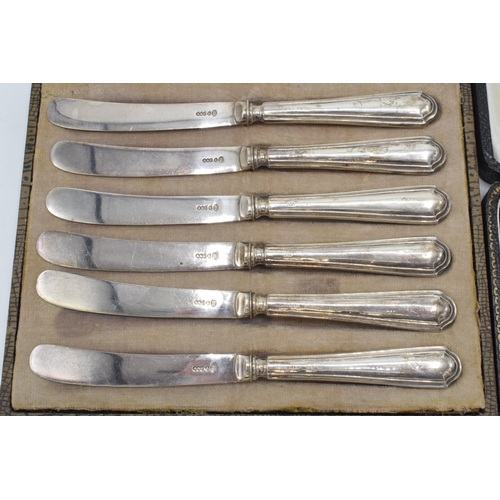 96 - A cased set of 6 silver handled butter knives, Sheffield 1926, together with a cased christening set... 