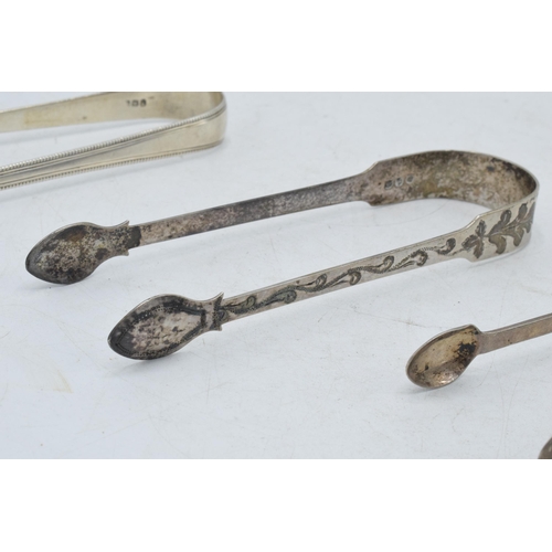 97 - A trio of silver sugar tongs to include 2 Georgian pair and one similar, 102.1 grams (3).