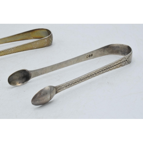 98 - A trio of hallmarked silver sugar tongs of varying designs to include 2 Georgian pairs and a similar... 