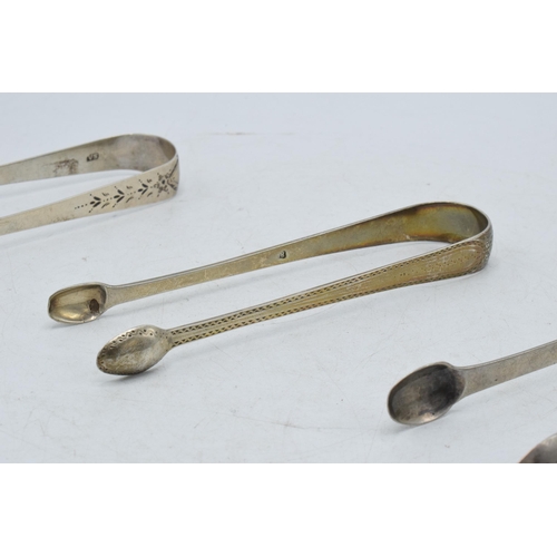 98 - A trio of hallmarked silver sugar tongs of varying designs to include 2 Georgian pairs and a similar... 