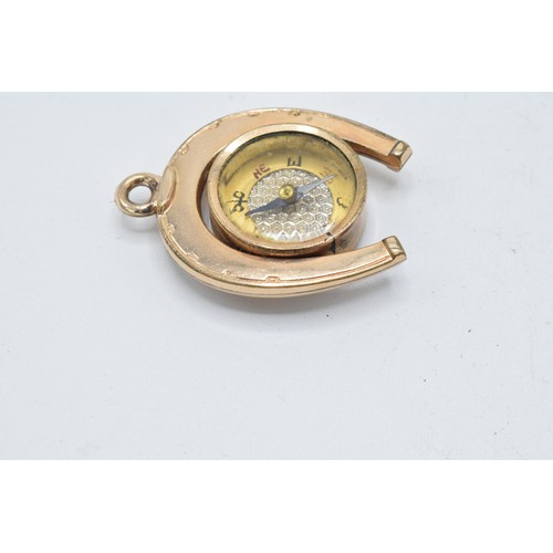 266 - Gold plated horseshoe watch fob with agate face and compass, 3.5cm long.