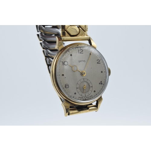 229A - Smiths 9ct gold cased wristwatch on gold plated metal strap, with inscription to rear.