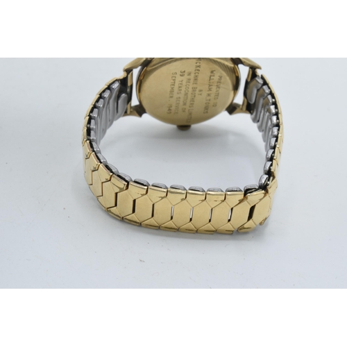 229A - Smiths 9ct gold cased wristwatch on gold plated metal strap, with inscription to rear.