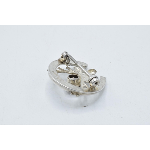 412A - Sterling silver brooch with deer's head and antlers amongst horseshoe set with stone, 25mm wide.