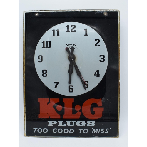 K.L.G Spark Plugs 'Too Good To Miss' Advertising Clock. Glass Back with Smiths Sectric Electric movement (untested). Automobilia interest. Salvaged from a local family run service station. 27cm x 36cm.