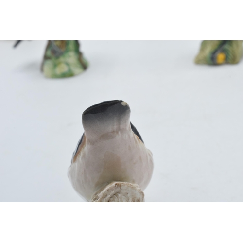 56 - A collection of Beswick birds to include a Bluetit, a Goldcrest, a Greenfinch, a Wren, a Nuthatch (c... 