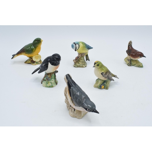 56 - A collection of Beswick birds to include a Bluetit, a Goldcrest, a Greenfinch, a Wren, a Nuthatch (c... 