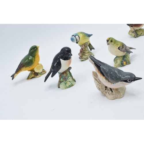 56 - A collection of Beswick birds to include a Bluetit, a Goldcrest, a Greenfinch, a Wren, a Nuthatch (c... 