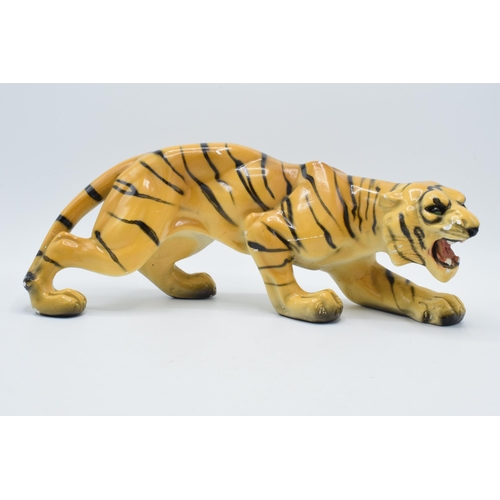 133 - Mid 20th century chalk ware model of a crouching tiger, RD 896256, 35cm long.