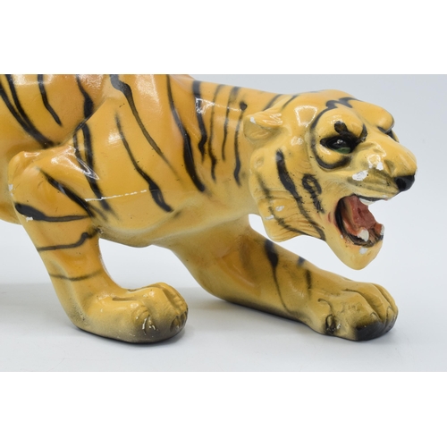 133 - Mid 20th century chalk ware model of a crouching tiger, RD 896256, 35cm long.