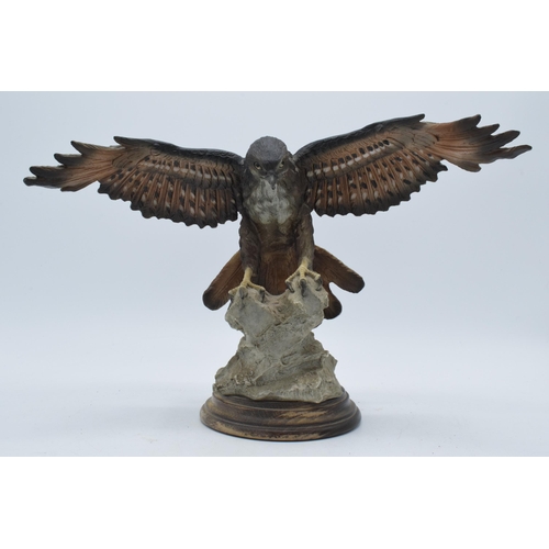 138 - Capo Di Monte realistic model of an Eagle / Bird of Prey landing on a rocky surface, 34cm wide.