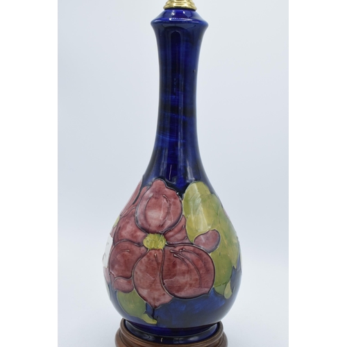 87 - Large Moorcroft unusual shaped pottery lampbase in the Hibiscus (or similar) floral pattern on turne... 