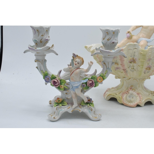 3 - A pair of 20th century Dresden style continental candlesticks with cherubs amongst foliage, made by ... 