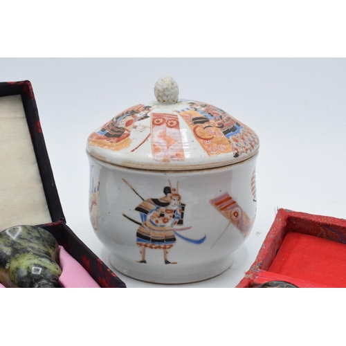 91 - An oriental low shouldered pot with traditional samurai scenes together with modern cased soapstone ... 