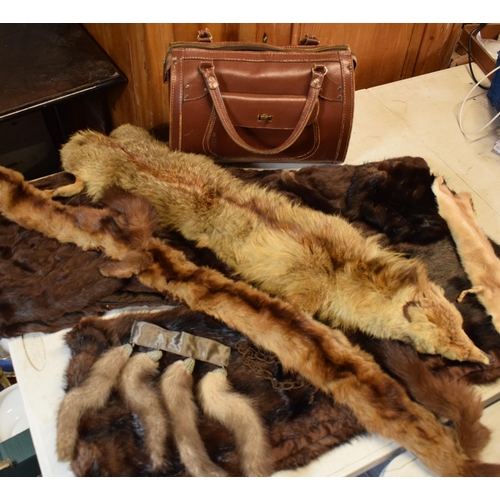 452C - A quantity of vintage furs, stoles and other items together with a vintage leather handbag.