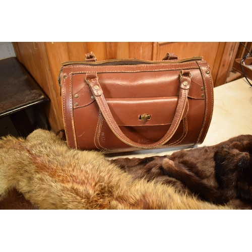 452C - A quantity of vintage furs, stoles and other items together with a vintage leather handbag.