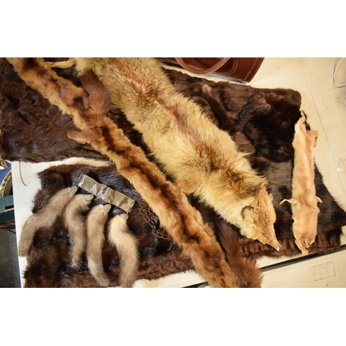 452C - A quantity of vintage furs, stoles and other items together with a vintage leather handbag.