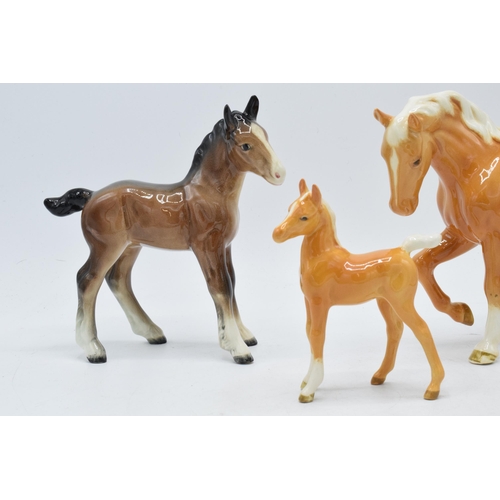 62 - Beswick palomino stocky jogging mare together with large brown foal with palomino foal (3).