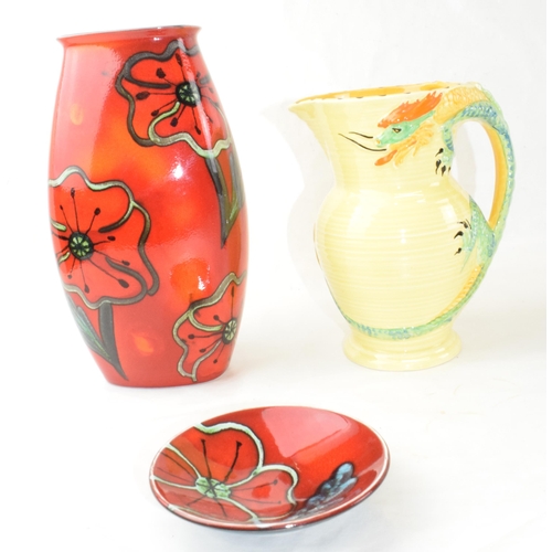 73 - A Poole Pottery vase together with Poole pin tray and a Burleigh Ware dragon handled vase. (3)