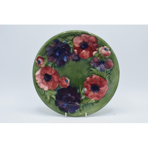 79 - Moorcroft floral charger on green background, 26cm diameter.