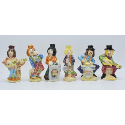 81 - A collection of Drioli novelty decanters in the form of a jazz band to include a piano player, a sax... 