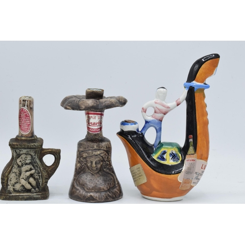 82 - A collection of novelty decanters to include a Drioli snake charmer, a Donkey,  stone effect bottles... 