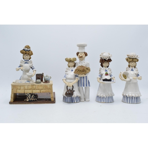 84 - A collection of Laura Dunn ceramic cooking figures to include a girl mixing, a couple with bread and... 