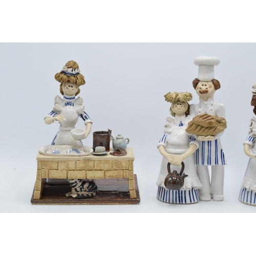 84 - A collection of Laura Dunn ceramic cooking figures to include a girl mixing, a couple with bread and... 