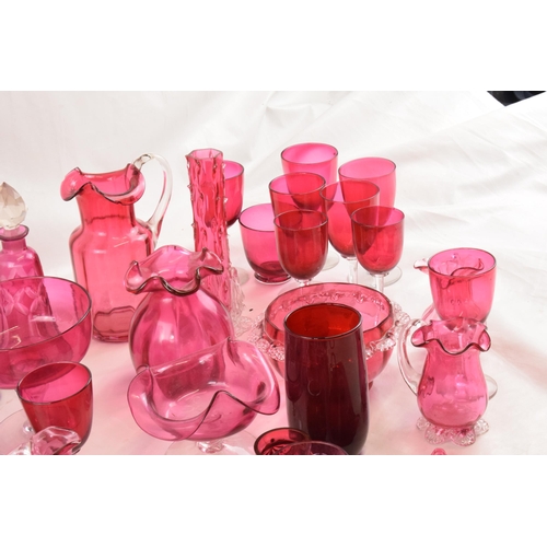 154 - A good collection of cranberry glass ware to include decanters, bowls, a Jack in the Pulpit hanging ... 